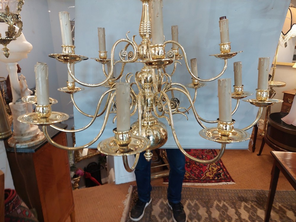 An 18th-century Dutch style polished brass chandelier featuring two tiers of curved arms, candle-style bulb holders, a central baluster stem, and a double-headed eagle crest. View VII