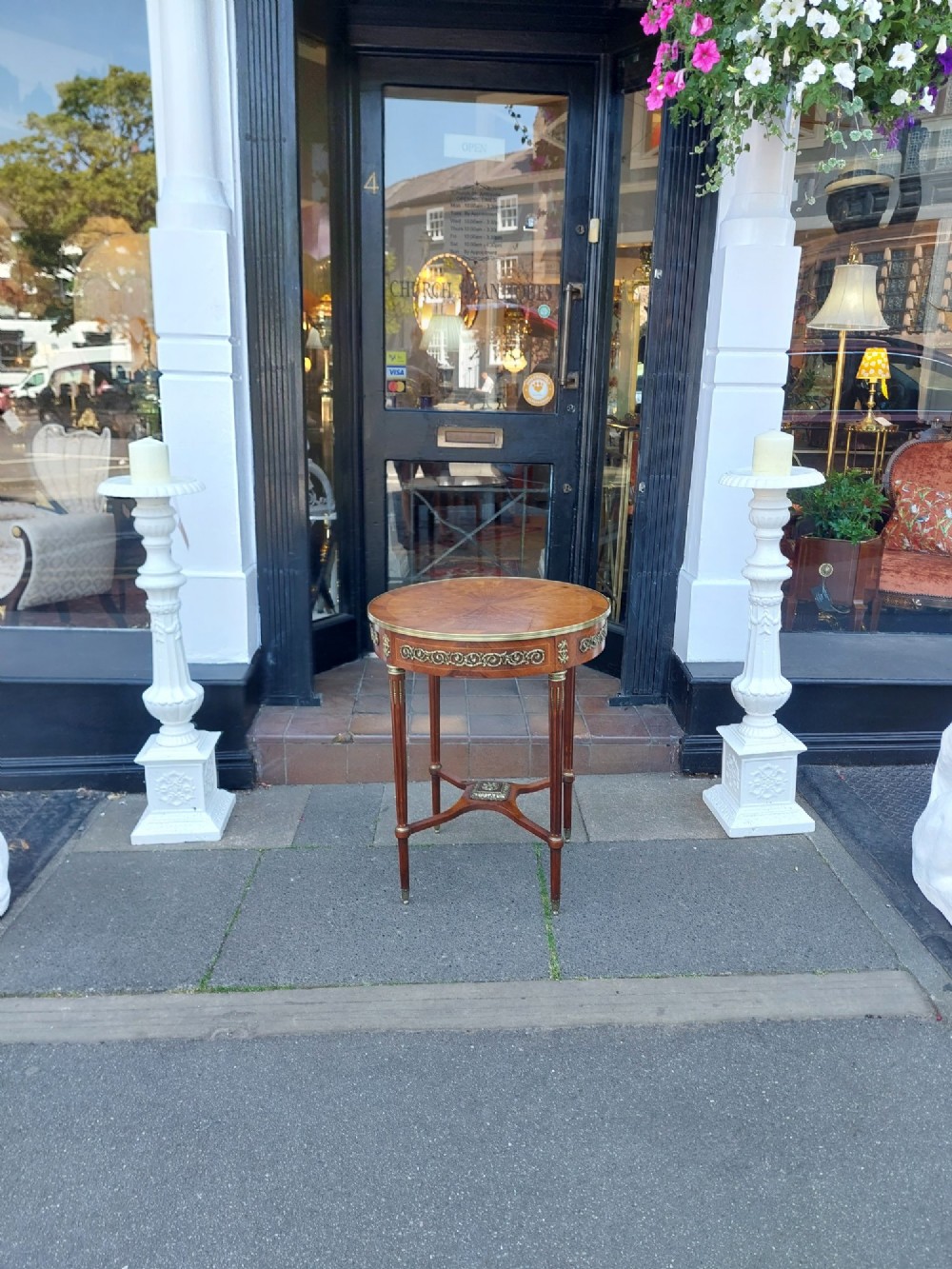 A mid-19th-century French Empire circular occasional table made of kingwood with a sunburst parquetry top and gilded metal mounts. View II