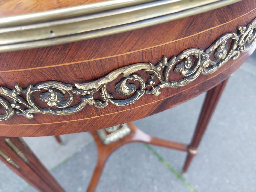 A mid-19th-century French Empire circular occasional table made of kingwood with a sunburst parquetry top and gilded metal mounts. View VI