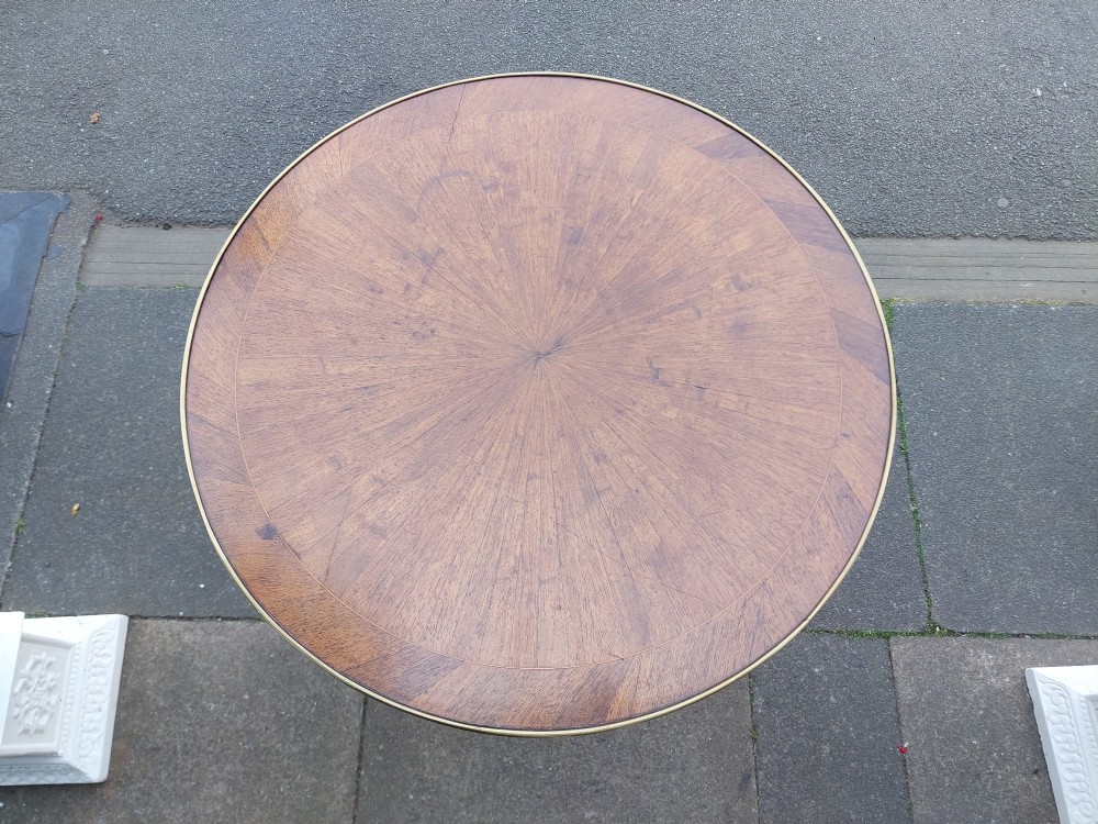 A mid-19th-century French Empire circular occasional table made of kingwood with a sunburst parquetry top and gilded metal mounts. View VII