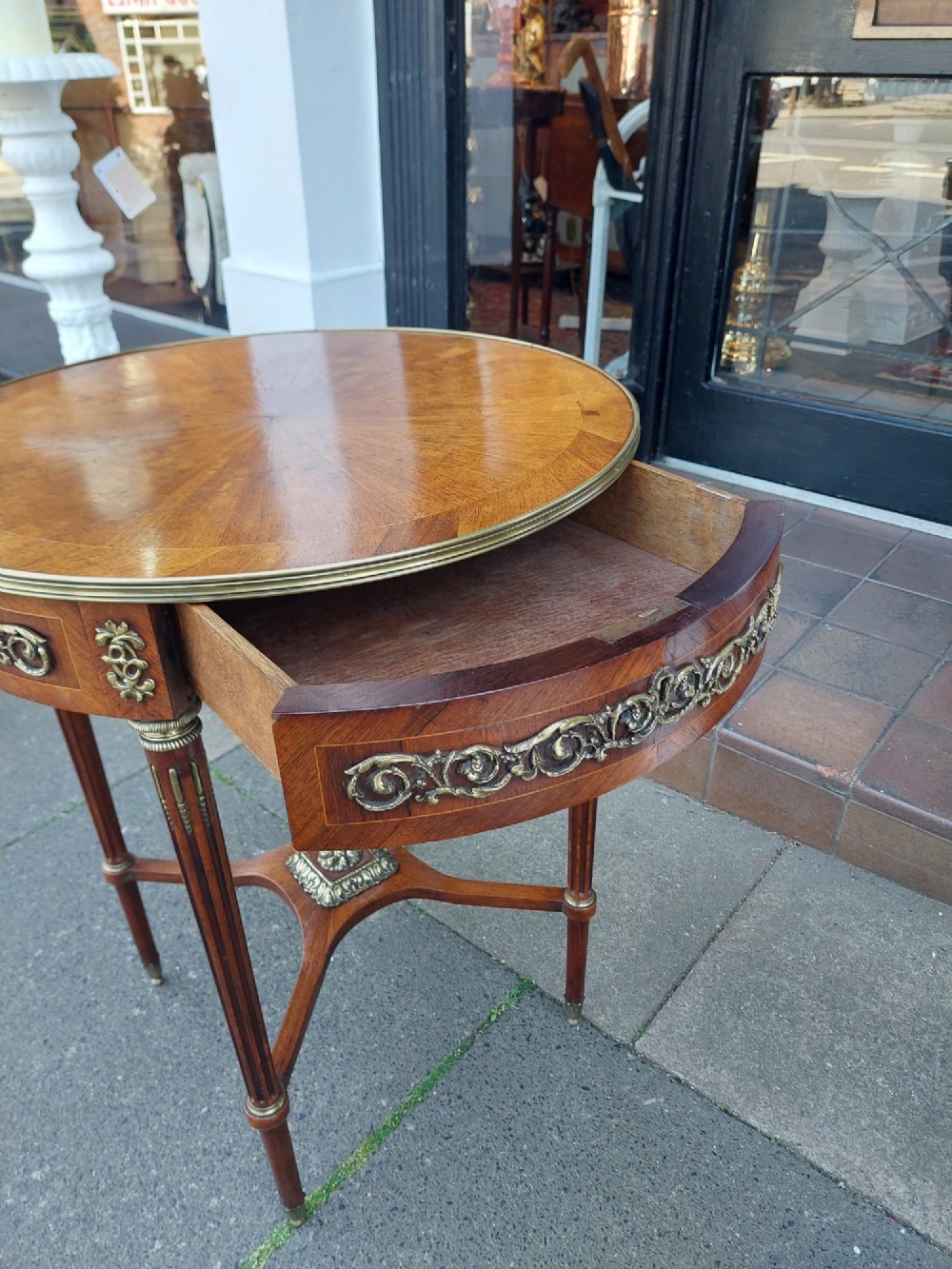 A mid-19th-century French Empire circular occasional table made of kingwood with a sunburst parquetry top and gilded metal mounts. View VIII