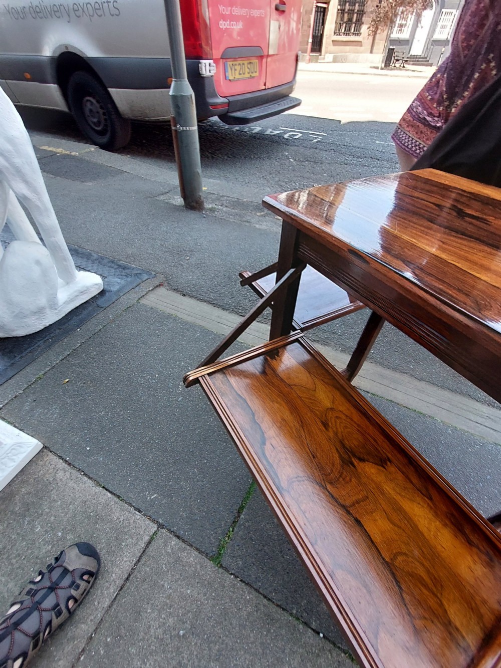 An Edwardian rosewood cake serving table featuring multiple drop-down folding side shelves and a polished rectangular top. View VI