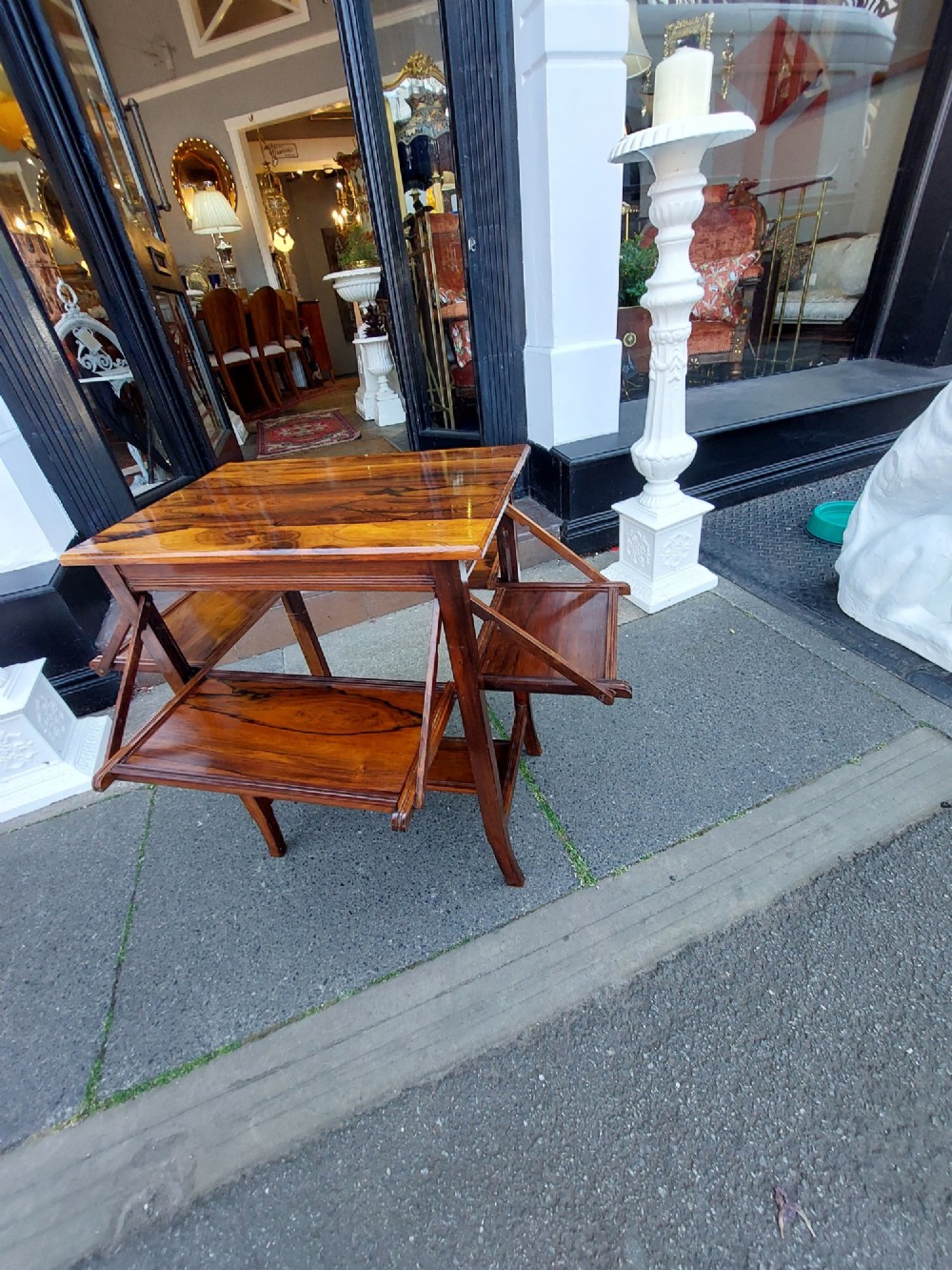 An Edwardian rosewood cake serving table featuring multiple drop-down folding side shelves and a polished rectangular top. View IX
