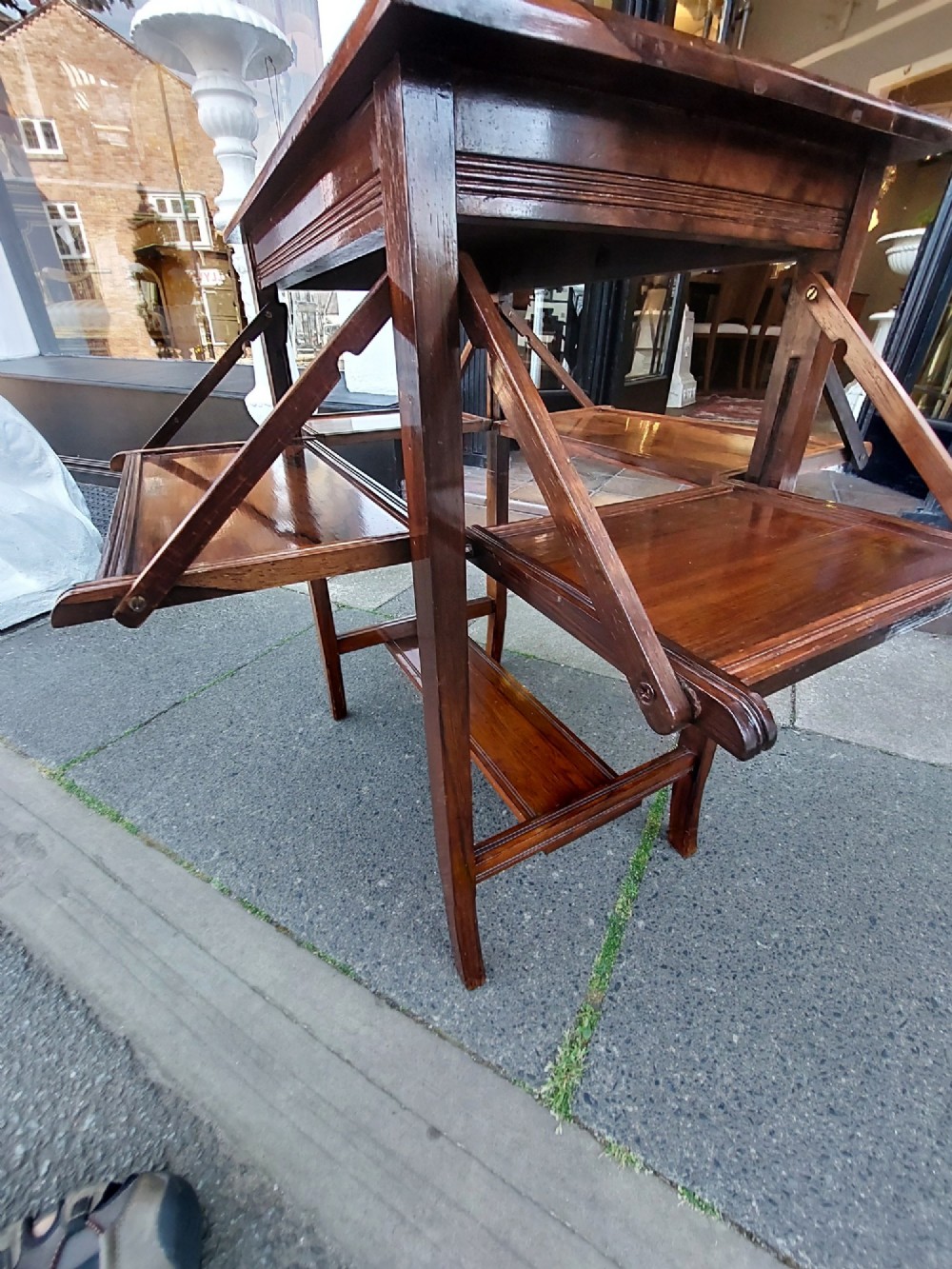 An Edwardian rosewood cake serving table featuring multiple drop-down folding side shelves and a polished rectangular top. View X