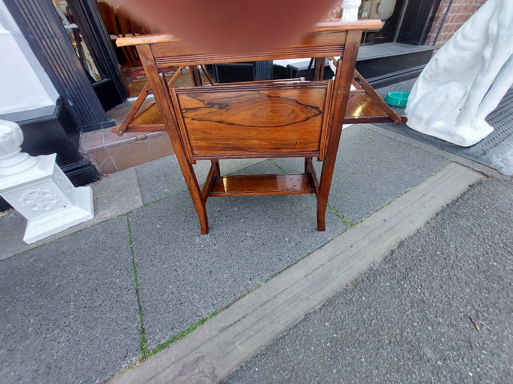 An Edwardian rosewood cake serving table featuring multiple drop-down folding side shelves and a polished rectangular top. View XI