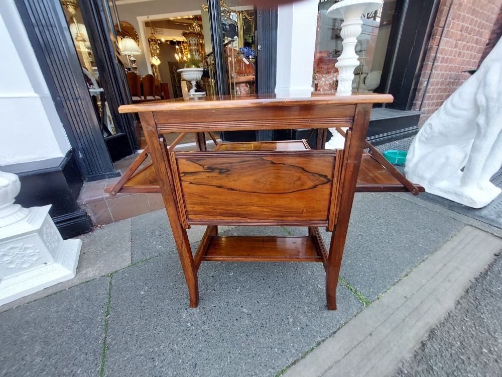 An Edwardian rosewood cake serving table featuring multiple drop-down folding side shelves and a polished rectangular top. View XII