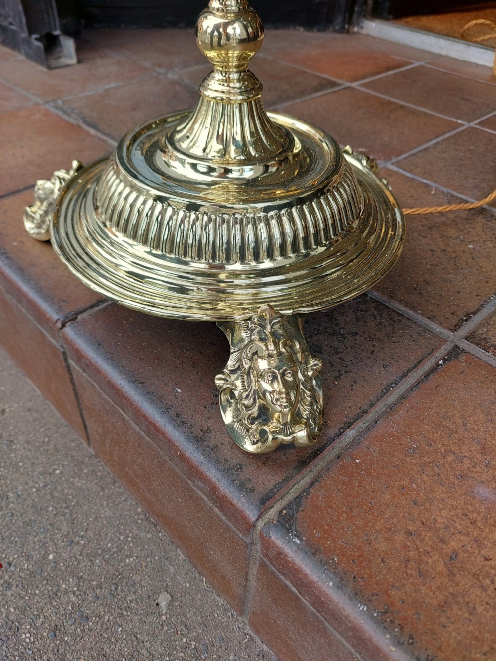 A Victorian brass standard floor lamp featuring a fluted column base and a scalloped green floral fabric shade with tassel fringe. View II