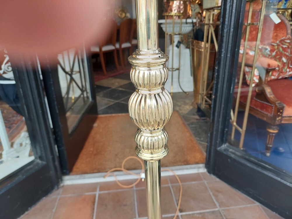 A Victorian brass standard floor lamp featuring a fluted column base and a scalloped green floral fabric shade with tassel fringe. View VI