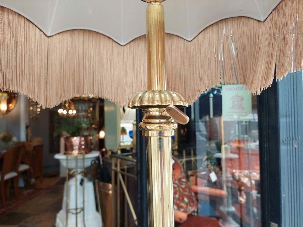 A Victorian brass standard floor lamp featuring a fluted column base and a scalloped green floral fabric shade with tassel fringe. View VII