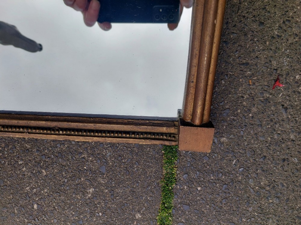 A Regency giltwood pier mirror featuring an architectural cornice, fluted side pilasters, and a blue verre eglomise glass frieze with a landscape scene. View III