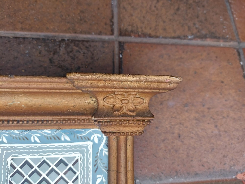 A Regency giltwood pier mirror featuring an architectural cornice, fluted side pilasters, and a blue verre eglomise glass frieze with a landscape scene. View VII