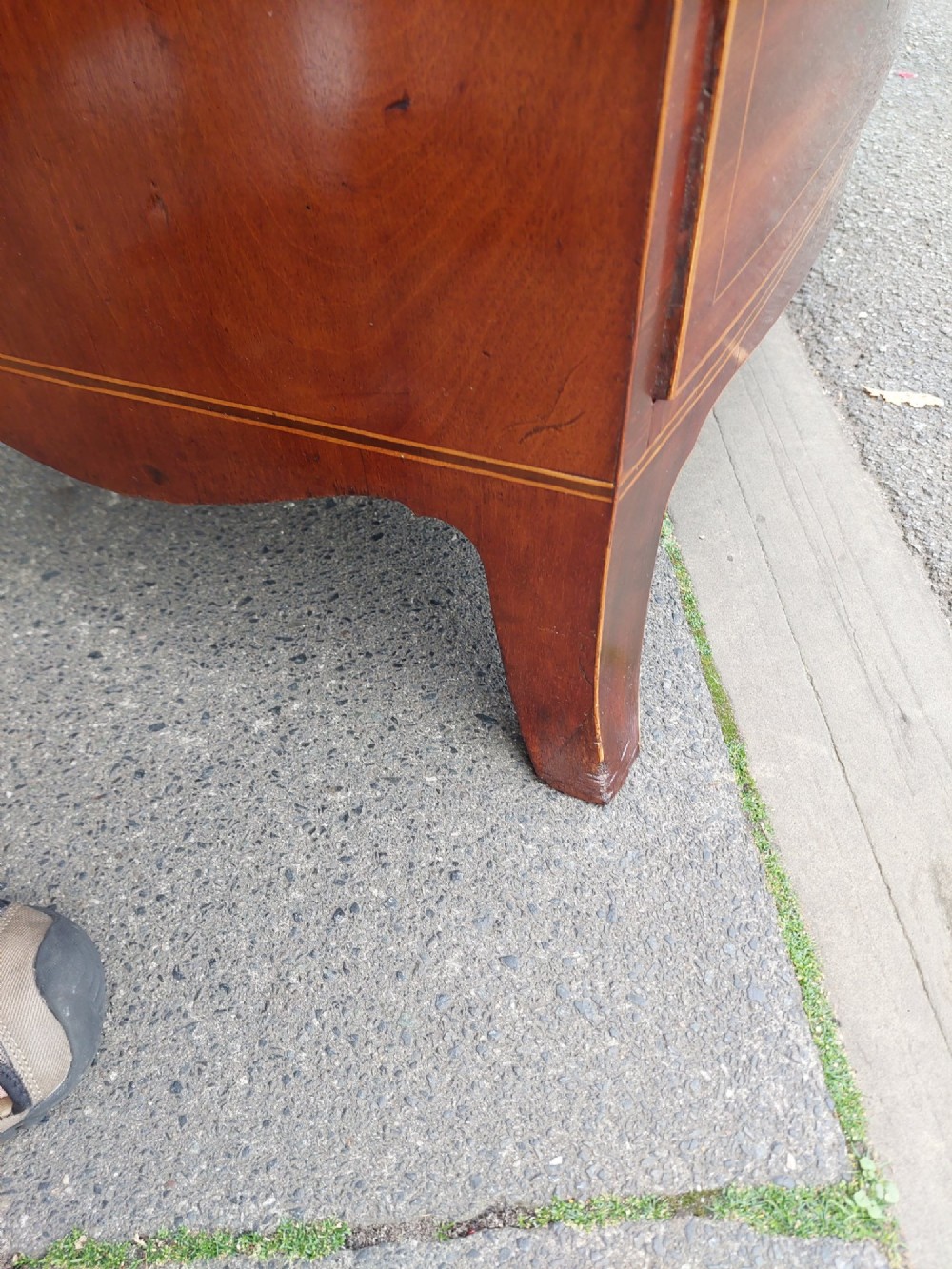 A Regency mahogany bow front chest featuring two short over two long drawers with oval brass handles, inlaid stringing, and splayed bracket feet. View VII