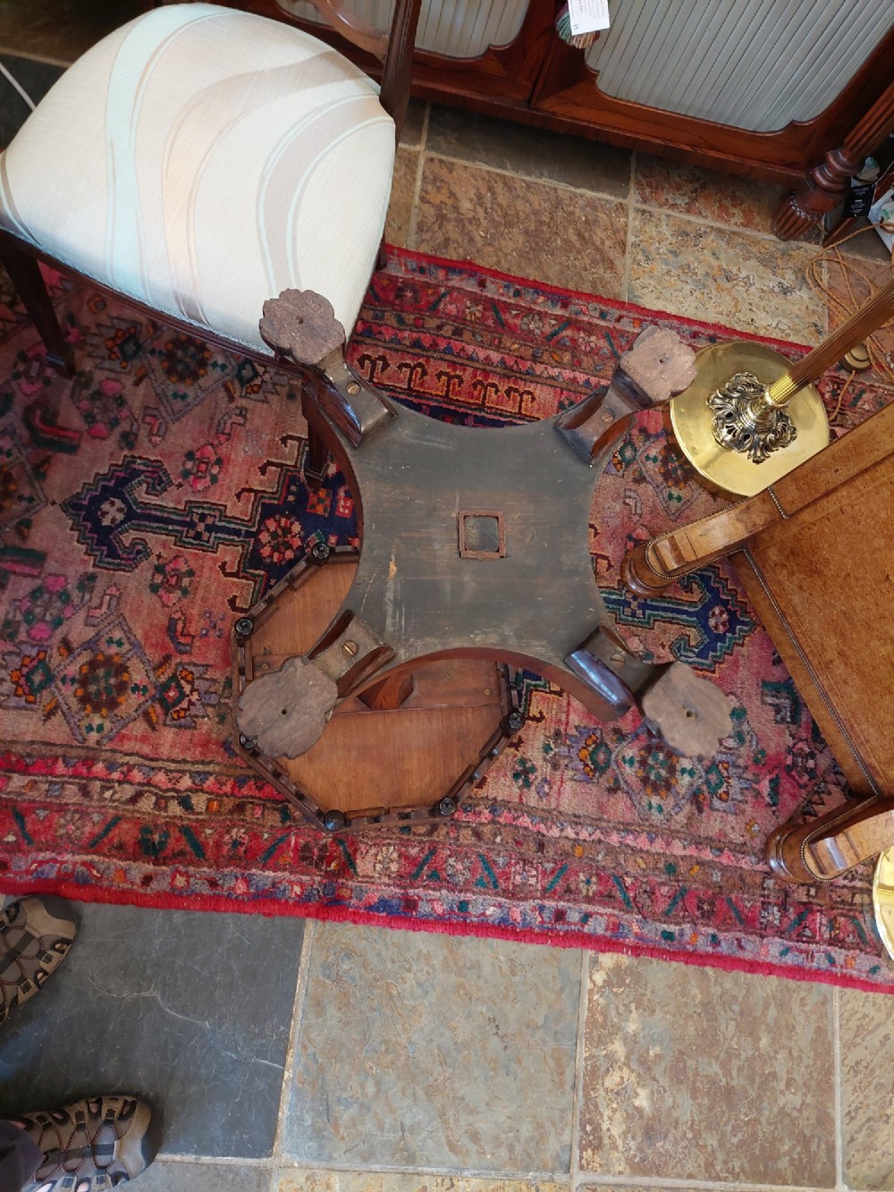 An antique William IV octagonal rosewood occasional table featuring a segmented veneer top, scalloped apron with drop finials, turned pedestal stem, and quadruped base with carved claw feet. View VII
