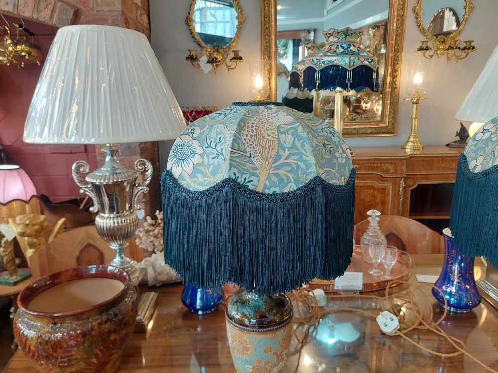 A pair of Royal Doulton Slaters Patent stoneware table lamps featuring patterned blue and gold ceramic bases paired with matching floral fringed fabric shades. View II