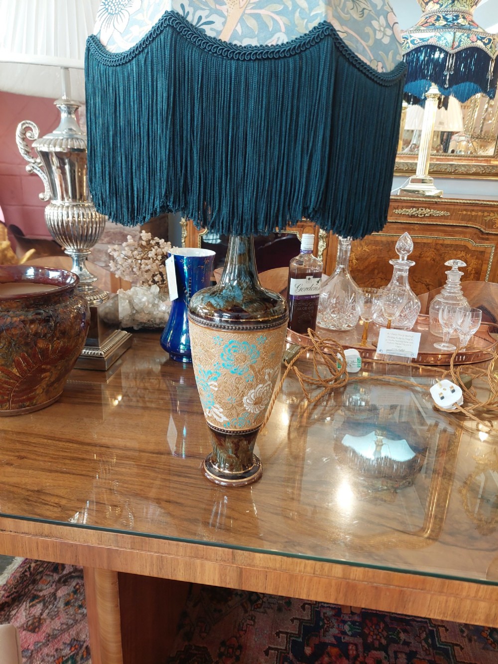 A pair of Royal Doulton Slaters Patent stoneware table lamps featuring patterned blue and gold ceramic bases paired with matching floral fringed fabric shades. View III