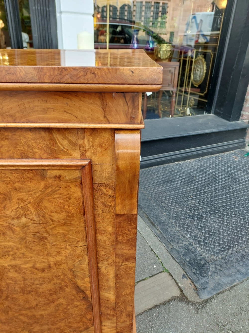 A Victorian burr walnut salon cabinet featuring two framed panel doors, carved support brackets, and a flat plinth base. View VIII