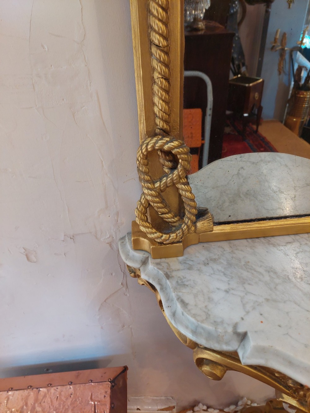 A tall late 19th-century French gilt gesso pier mirror featuring a rope-twist border and top ribbon motif, mounted above a small marble-topped single-leg console. View III