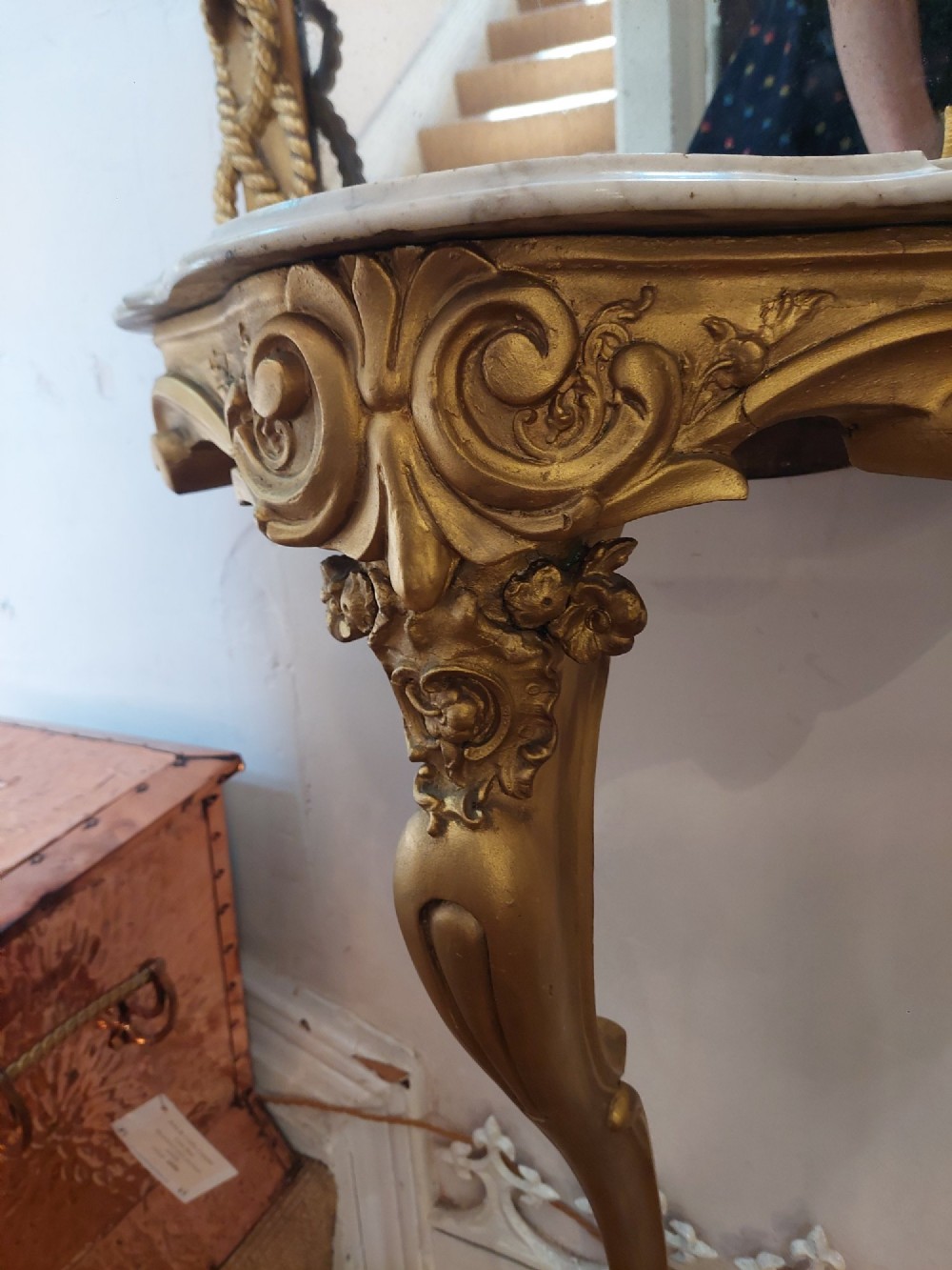 A tall late 19th-century French gilt gesso pier mirror featuring a rope-twist border and top ribbon motif, mounted above a small marble-topped single-leg console. View VII