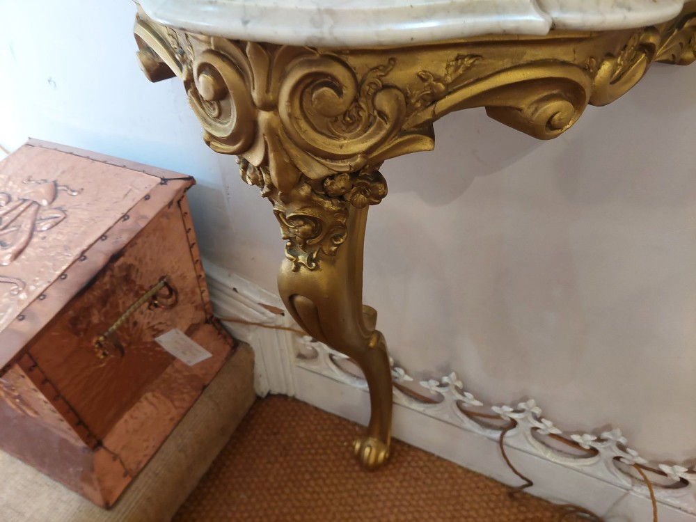 A tall late 19th-century French gilt gesso pier mirror featuring a rope-twist border and top ribbon motif, mounted above a small marble-topped single-leg console. View IX