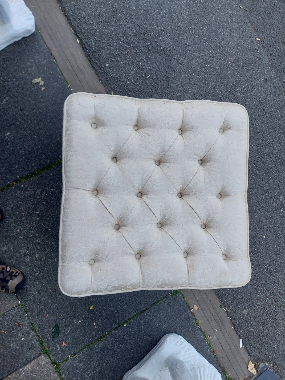 A Victorian walnut stool featuring carved cabriole legs, a serpentine apron, and a cream button-tufted upholstered top. View V