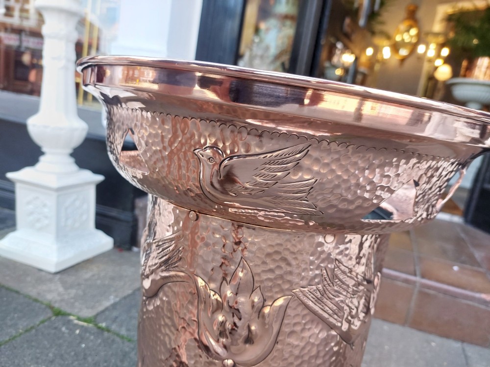Cylindrical Art Nouveau copper umbrella stand with embossed organic relief motifs, a flared top rim, and a weighted base. View V