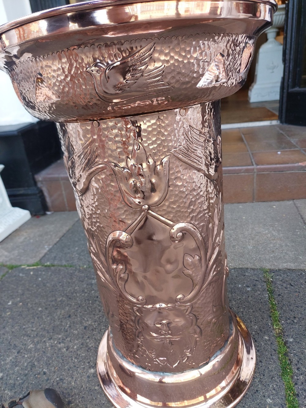 Cylindrical Art Nouveau copper umbrella stand with embossed organic relief motifs, a flared top rim, and a weighted base. View VI