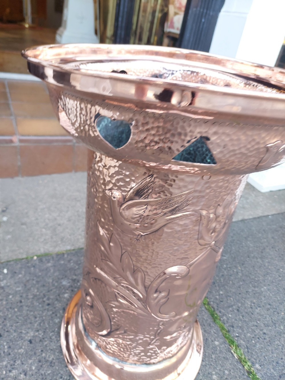 Cylindrical Art Nouveau copper umbrella stand with embossed organic relief motifs, a flared top rim, and a weighted base. View VII