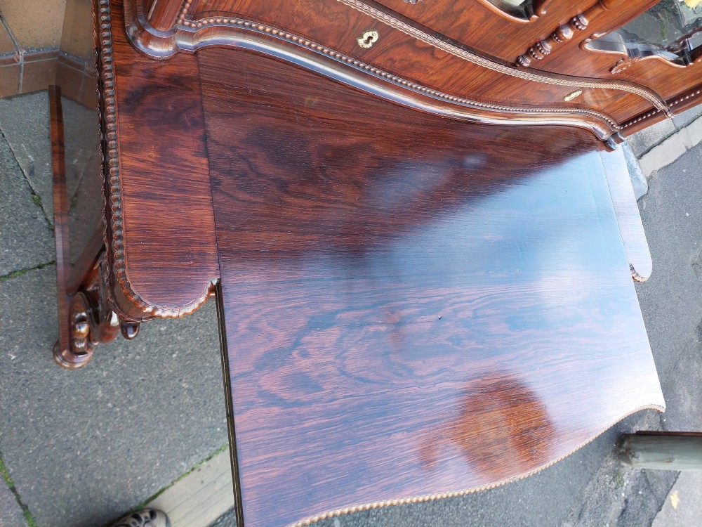A two-tier Biedermeier rosewood display cabinet featuring a glazed upper section with a carved cresting above a two-door cupboard base. View XIII