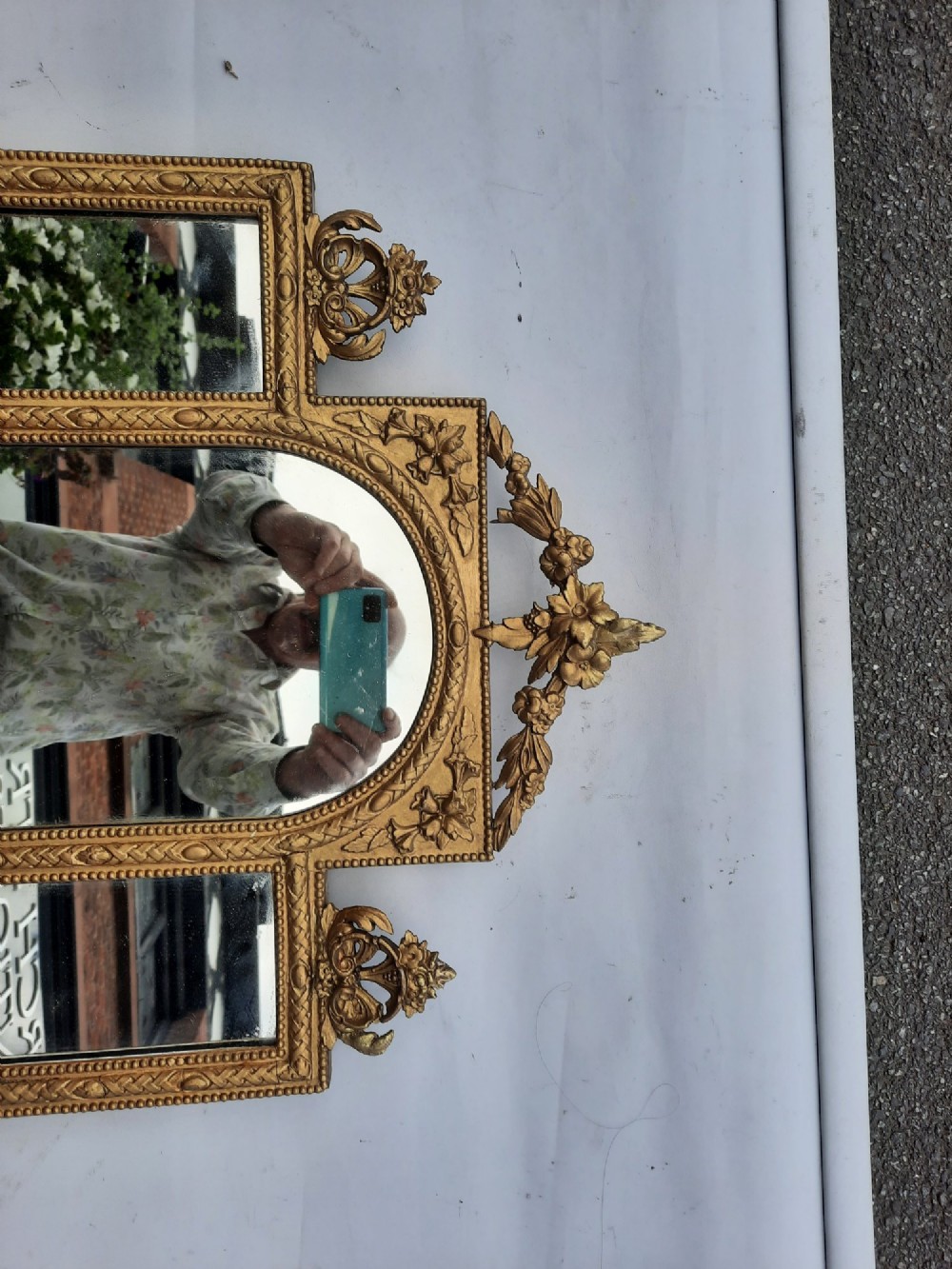 A late nineteenth-century three-panel gilt wall mirror featuring an arched central plate, intricate carved floral cresting, and an integrated base shelf. View IV