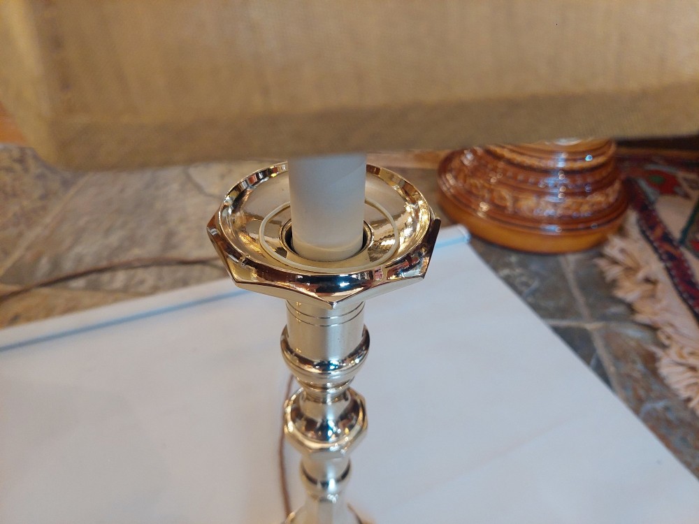 A pair of polished Victorian brass candlestick table lamps fitted with hexagonal beige fabric shades. View V