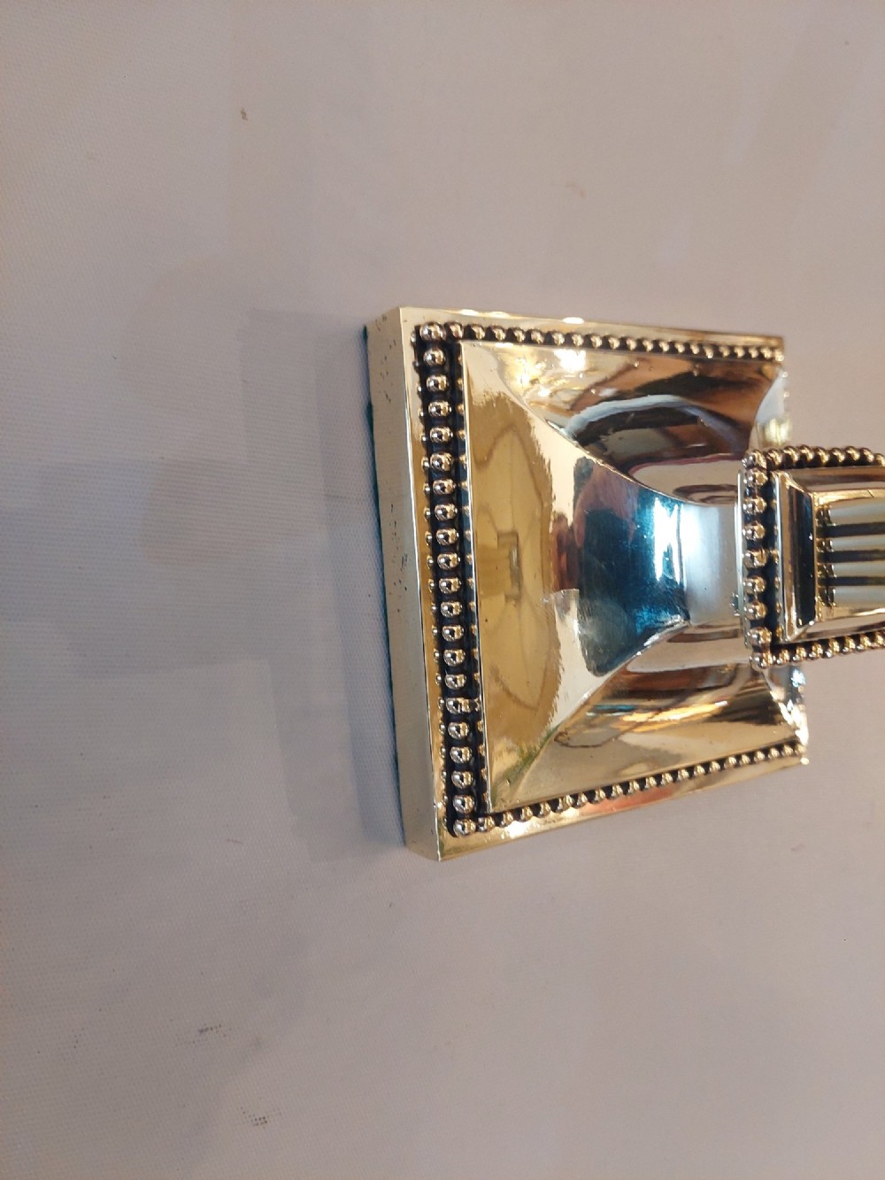 An Edwardian Neoclassical Revival silver-plated table lamp featuring a fluted column stem, square stepped base, and a cream fabric shade adorned with beaded fringe. View II