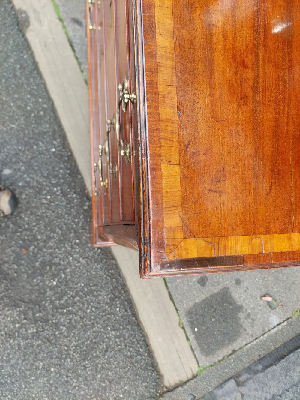 A George III mahogany bachelors chest featuring four graduated drawers, brass swan-neck handles, an upper pull-out brushing slide, and classic bracket feet. View IX