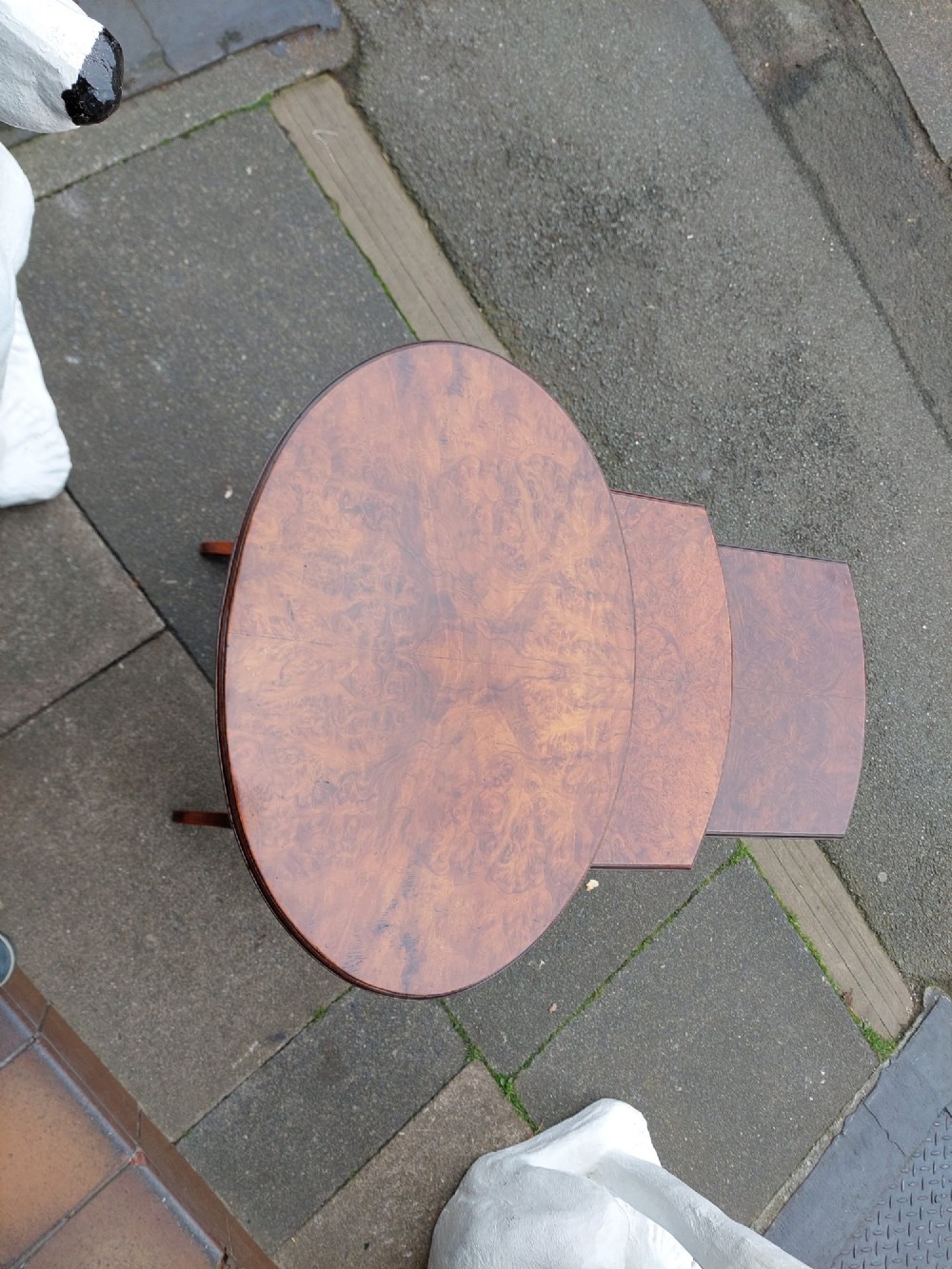 A set of three Edwardian nesting tables crafted from burr walnut with slender turned legs, stretcher supports, and shaped tops. View II