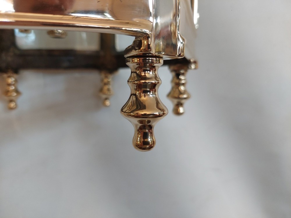 A hexagonal polished brass ceiling lantern with clear glass side panels, scrolled top canopy, and turned bottom finials. View IX