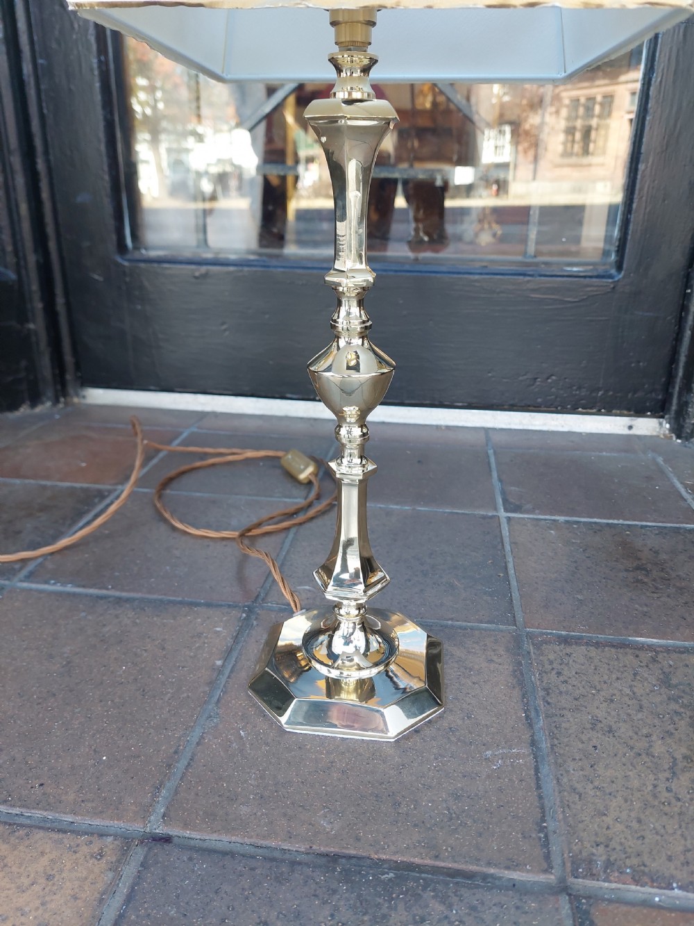 An Art Nouveau silvered brass table lamp featuring a hexagonal faceted stem and a white tapered shade printed with a pastoral scene. View VI