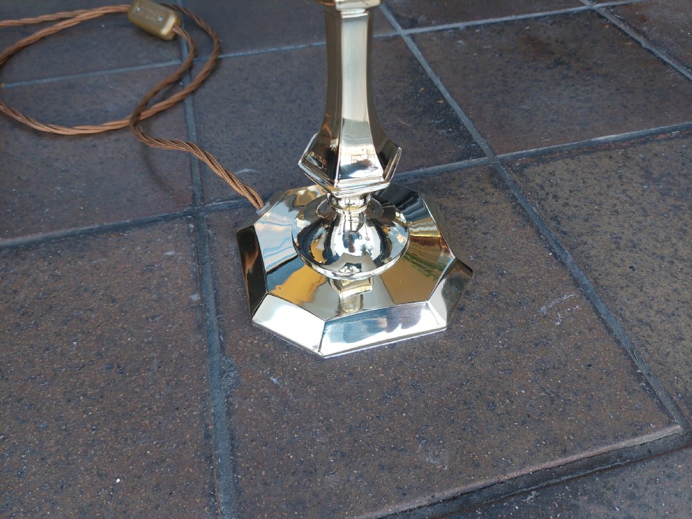 An Art Nouveau silvered brass table lamp featuring a hexagonal faceted stem and a white tapered shade printed with a pastoral scene. View IX