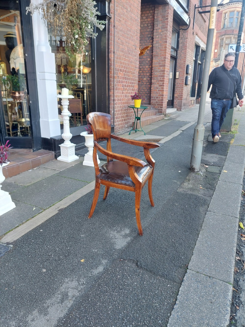 A 19th-century French elm desk chair featuring a curved backrest, sweeping armrests, and a dark leather upholstered seat. View III