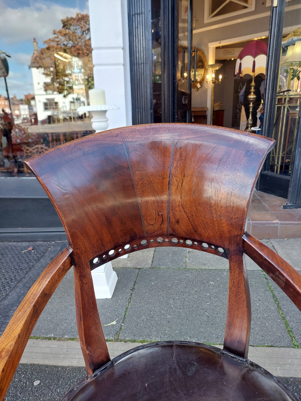 A 19th-century French elm desk chair featuring a curved backrest, sweeping armrests, and a dark leather upholstered seat. View IV