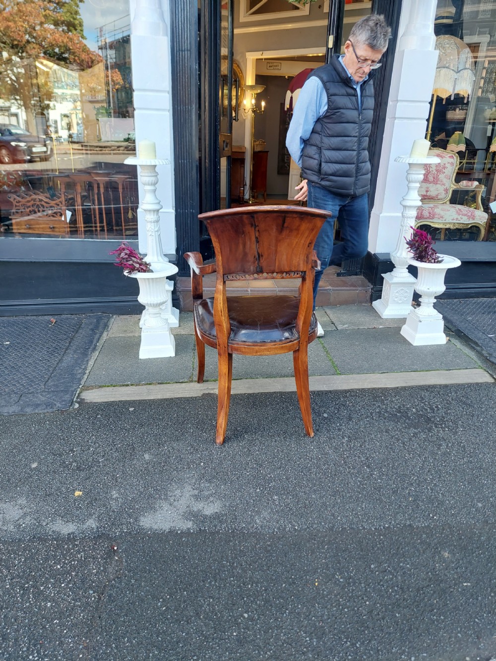 A 19th-century French elm desk chair featuring a curved backrest, sweeping armrests, and a dark leather upholstered seat. View VIII