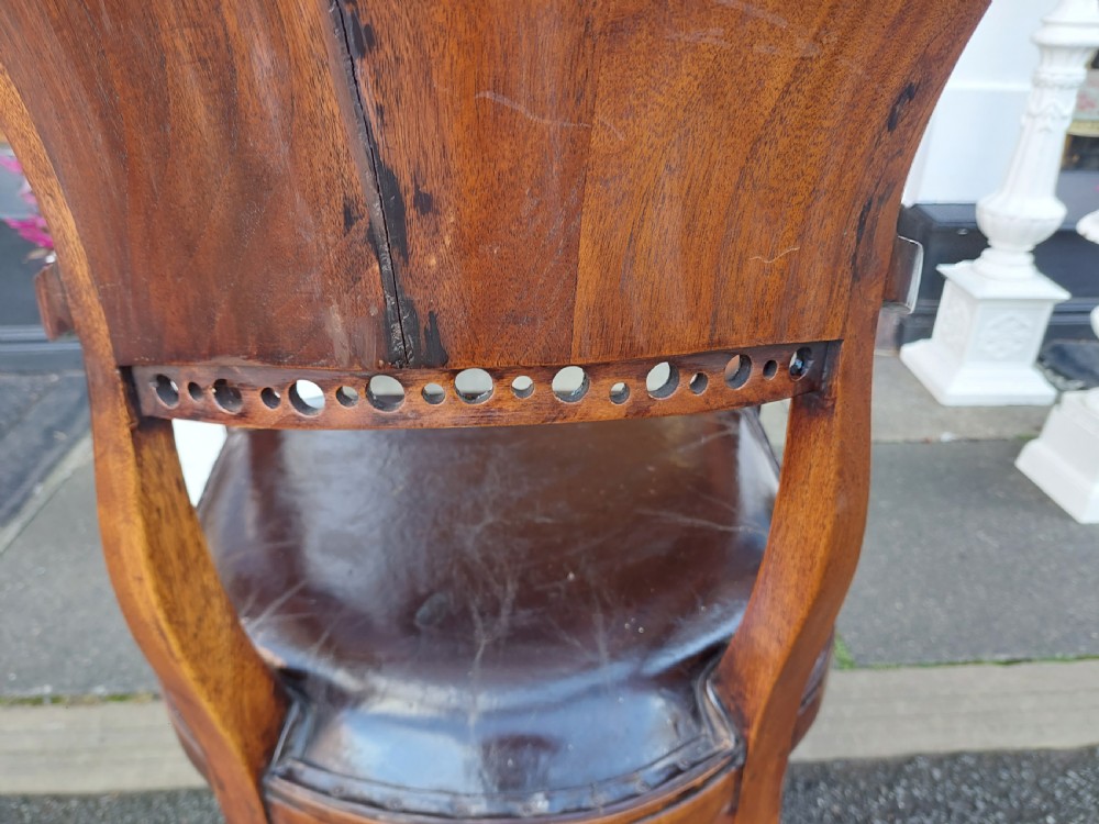 A 19th-century French elm desk chair featuring a curved backrest, sweeping armrests, and a dark leather upholstered seat. View IX