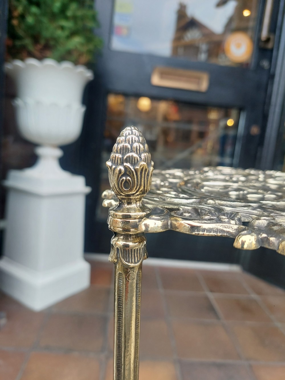A Victorian three-tier brass stand featuring pierced fretwork platforms, vertical turned columns, and decorative scroll feet. View III