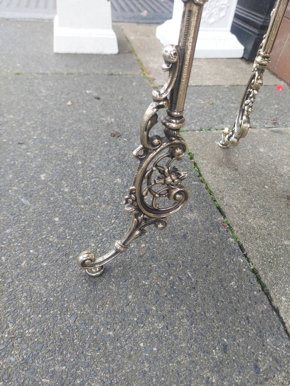 A Victorian three-tier brass stand featuring pierced fretwork platforms, vertical turned columns, and decorative scroll feet. View IV