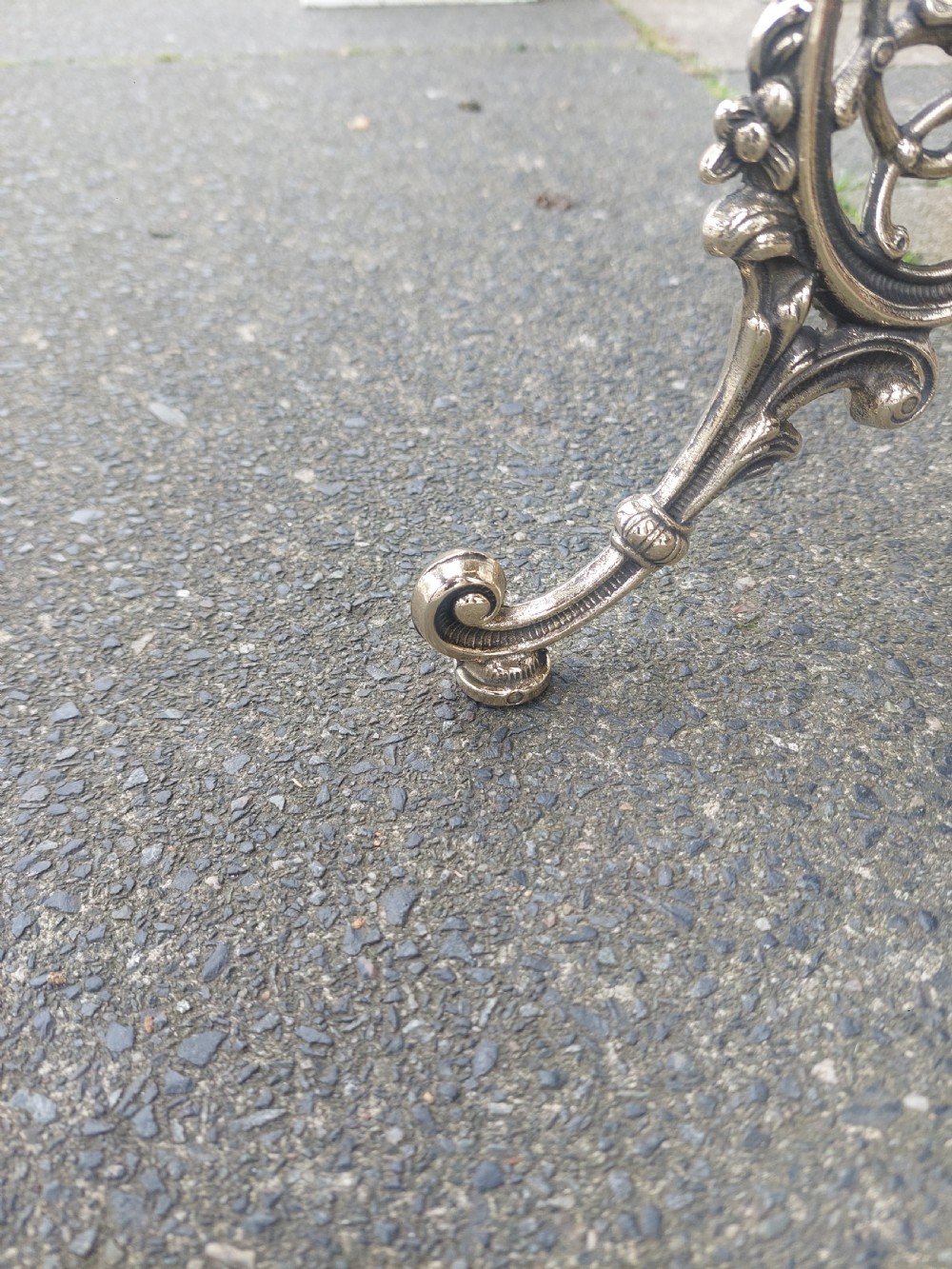 A Victorian three-tier brass stand featuring pierced fretwork platforms, vertical turned columns, and decorative scroll feet. View V