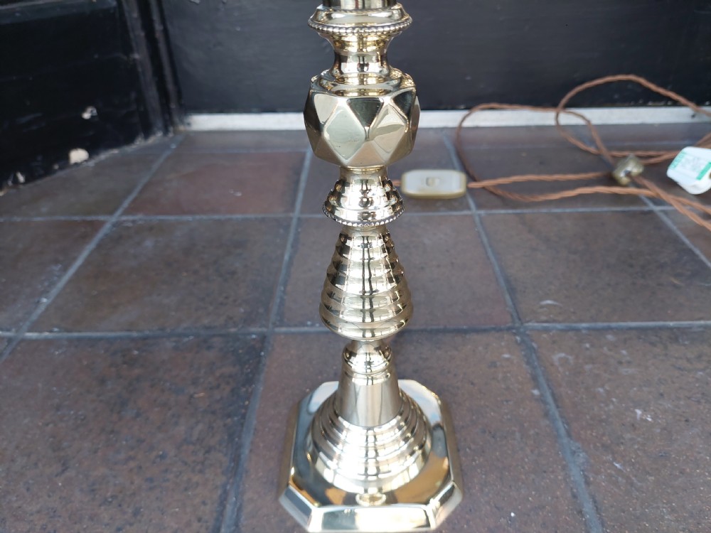 A pair of turned brass Edwardian candlestick table lamps fitted with white pleated lampshades. View III