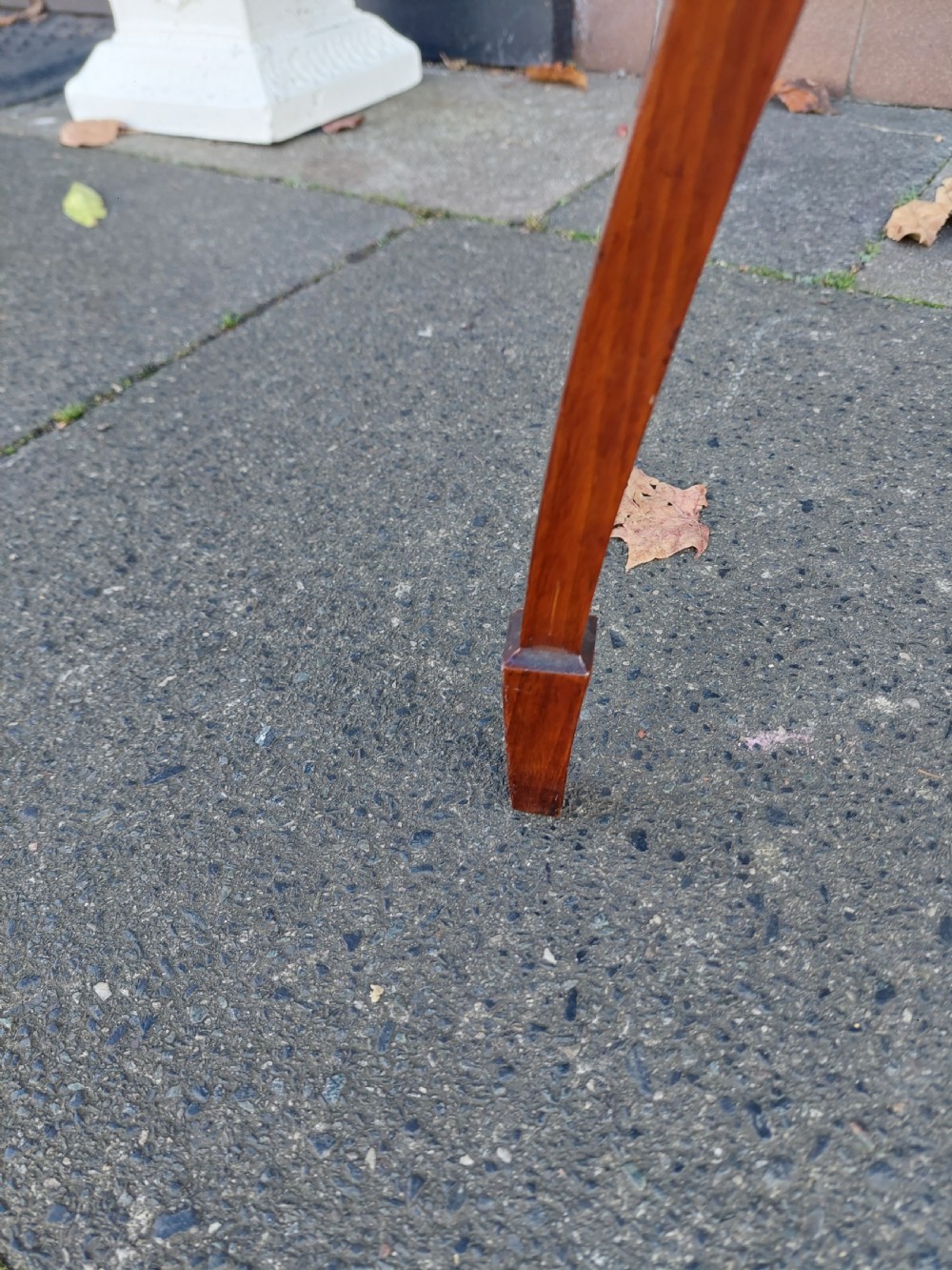 An Edwardian circular walnut vase stand with slender splayed legs and a lower triangular tier. View III