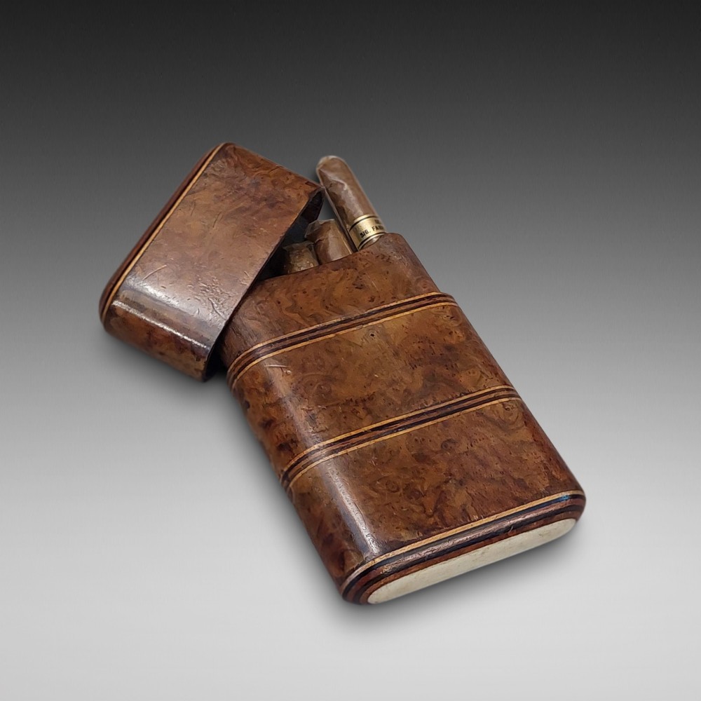 A late nineteenth-century pocket cigar case made from burr walnut with inlaid line detailing, shown partially open to reveal cigars inside.