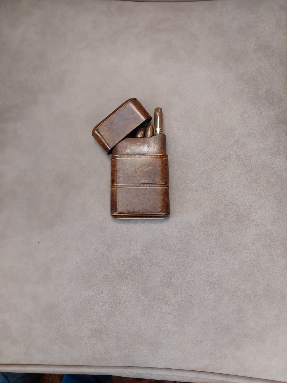 A late nineteenth-century pocket cigar case made from burr walnut with inlaid line detailing, shown partially open to reveal cigars inside. View IV