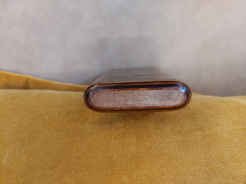A late nineteenth-century pocket cigar case made from burr walnut with inlaid line detailing, shown partially open to reveal cigars inside. View VI