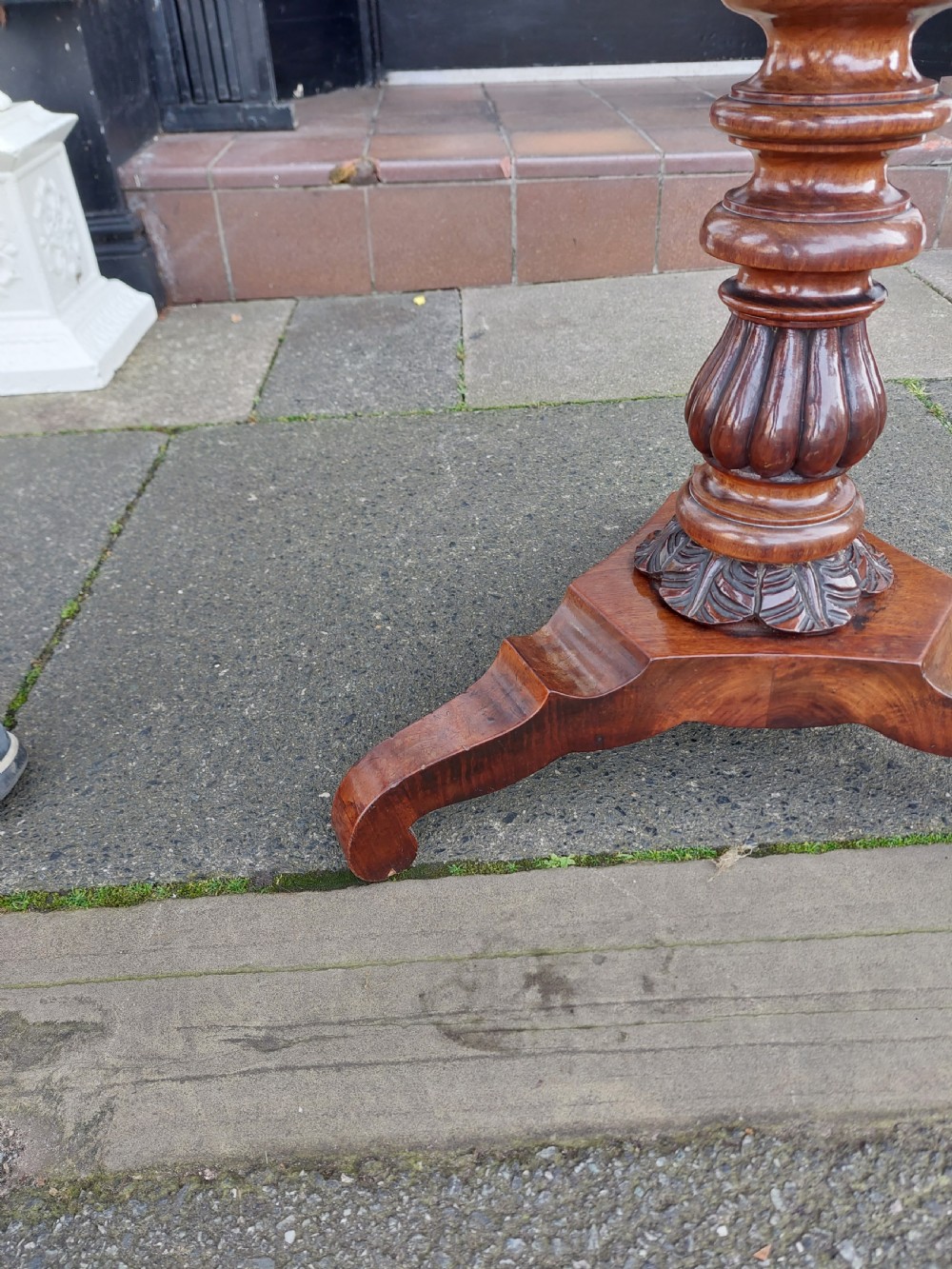 A flame mahogany Victorian sewing table featuring a canted corner top, a faceted turned pedestal column, and a scroll-cut tripod base. View VIII