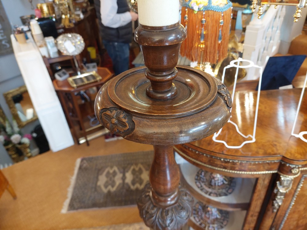 A matched pair of turned dark oak standard lamps featuring ornate burgundy and cream patterned fabric shades with tassel fringe. View VIII